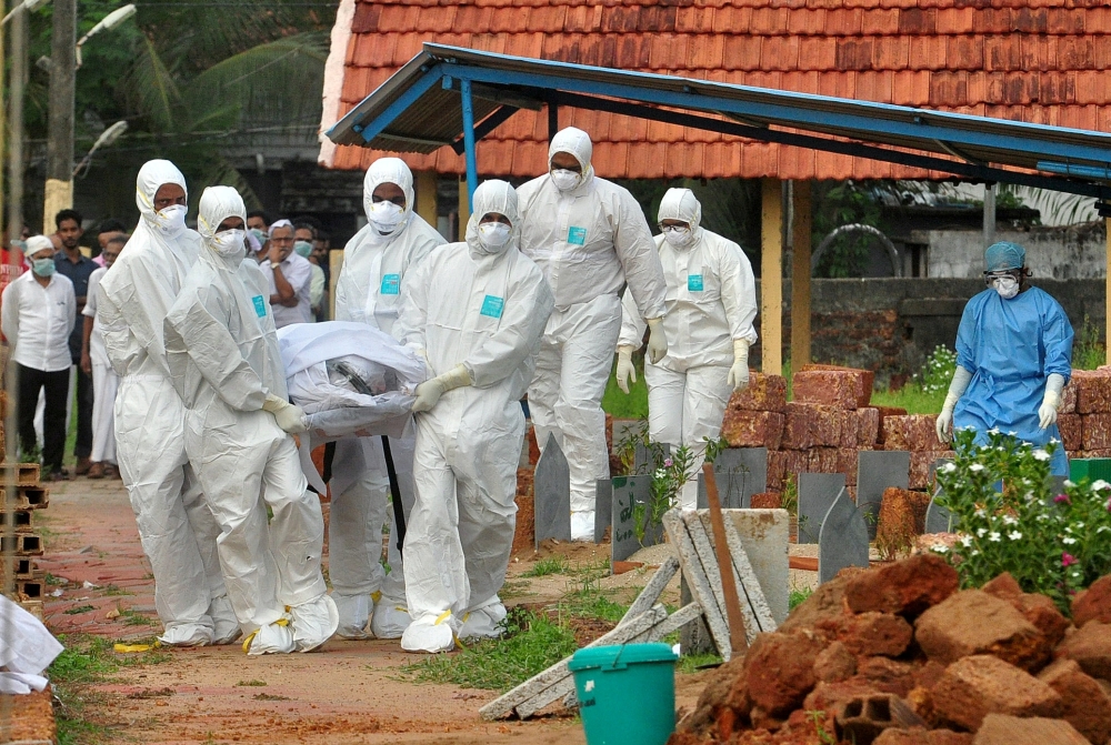 Representational file photo. Doctors and relatives wearing protective gear dig a grave to bury a victim of the brain-damaging Nipah virus in Kozhikode, Kerala, India, May 24, 2018. Reuters/Stringer