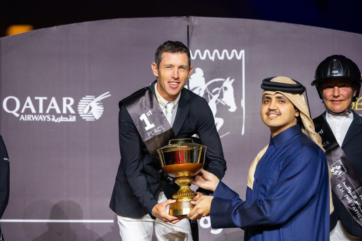 Chairman of the Board of Directors of Qatar Fund for Development H E Sheikh Thani bin Hamad Al Thani hands the trophy to Britain’s Scott Brash.