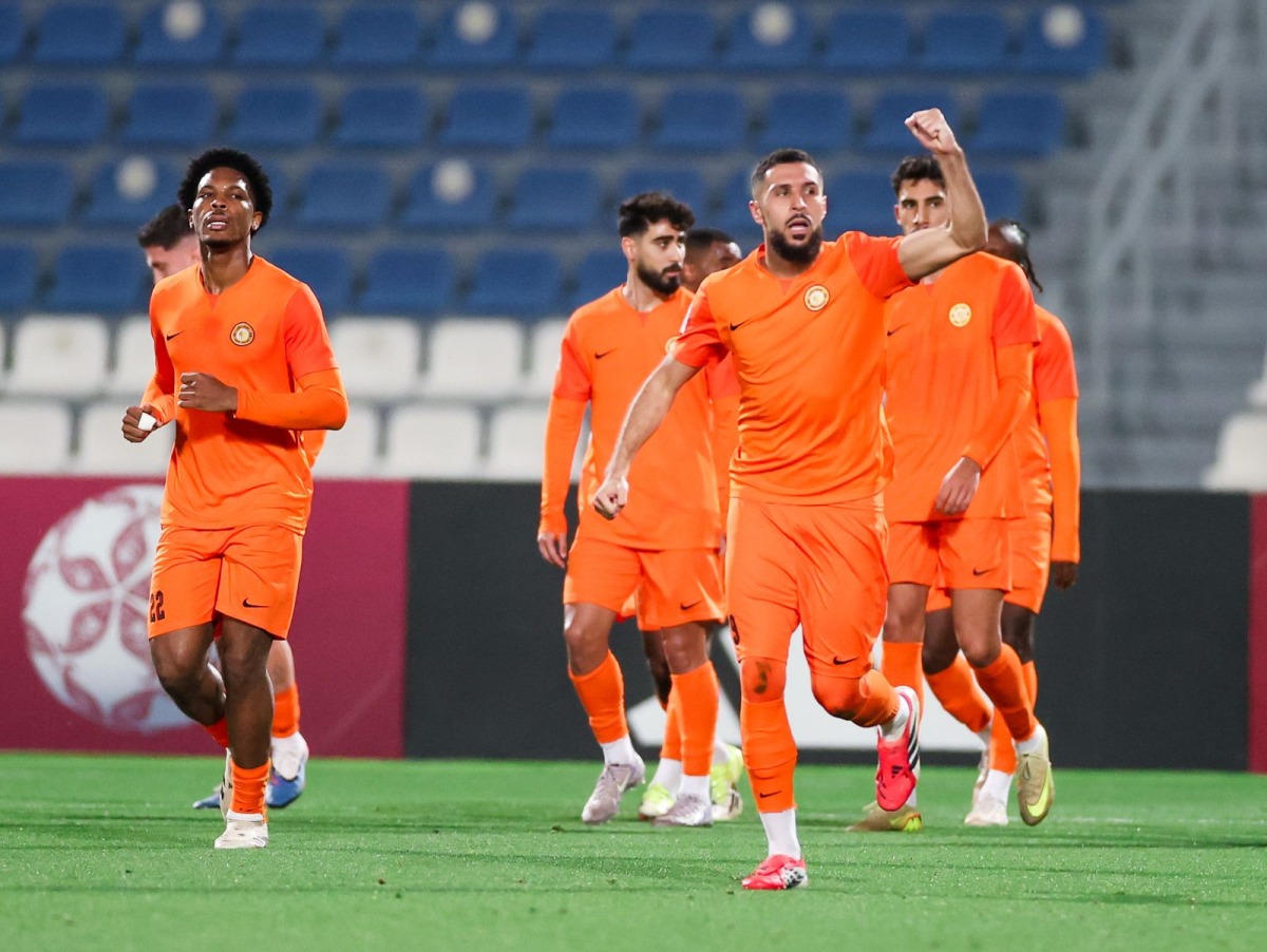 Umm Salal's Naim Laidouni (centre) celebrates after scoring a goal.