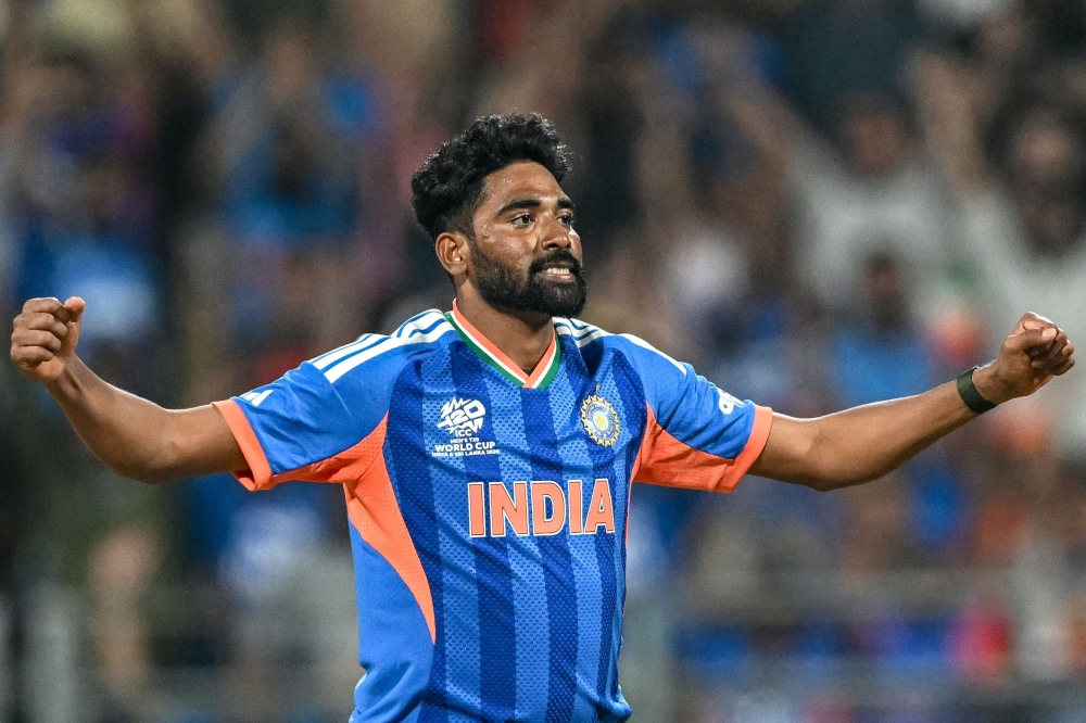 India's Mohammed Siraj reacts after taking the wicket of USA's Saiteja Mukkamalla during the 2026 ICC Men's T20 Cricket World Cup group stage match between India and USA at the Wankhede Stadium in Mumbai on February 7, 2026. (Photo by Punit Paranjpe / AFP)
 