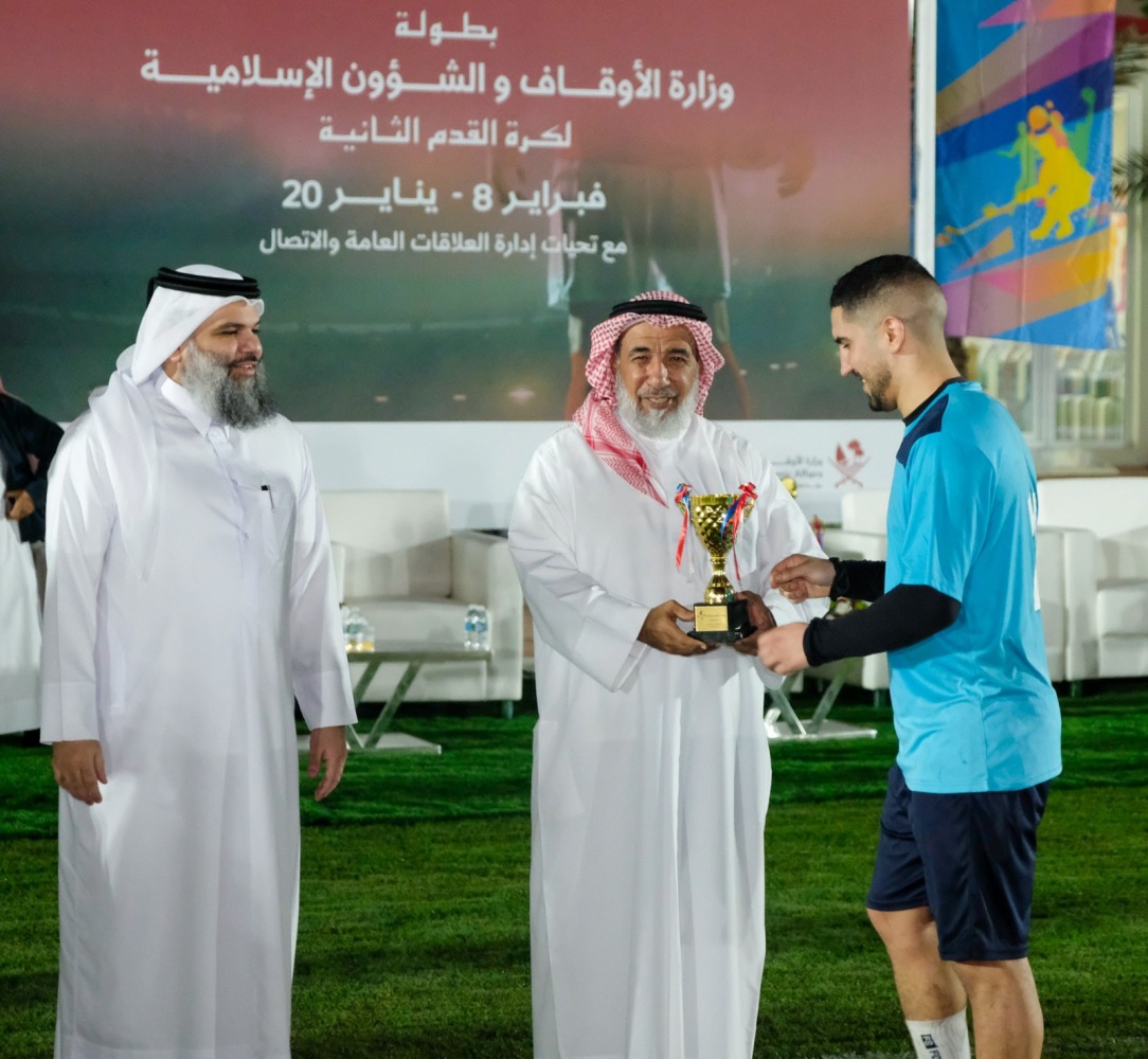 Minister of Awqaf and Islamic Affairs H E Ghanem bin Shaheen bin Ghanem Al Ghanem honouring a winner at the event.