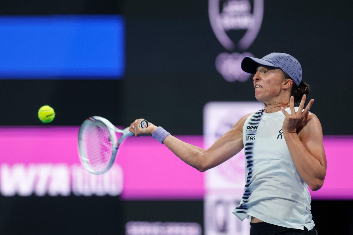 Poland’s Iga Swiatek hits a return against Australia's Daria Kasatkina. (AFP)