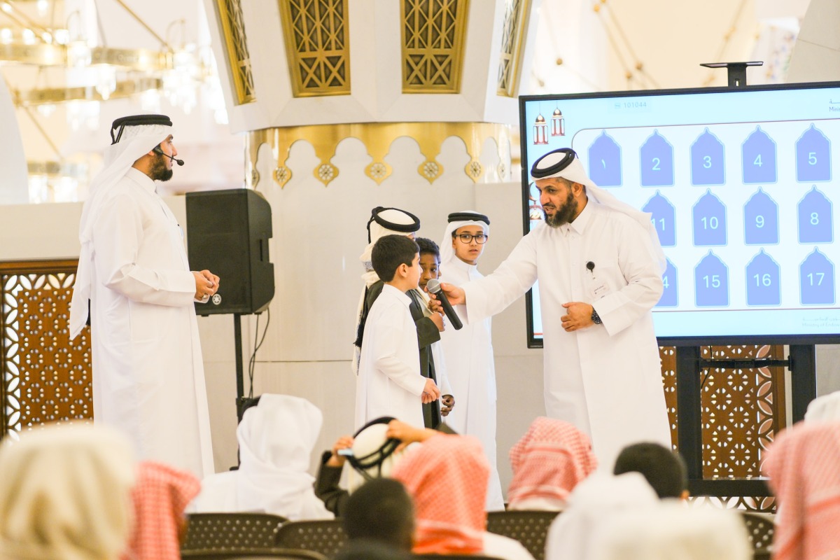 Officials with students during the event at Imam Muhammad bin Abdul Wahhab Mosque.