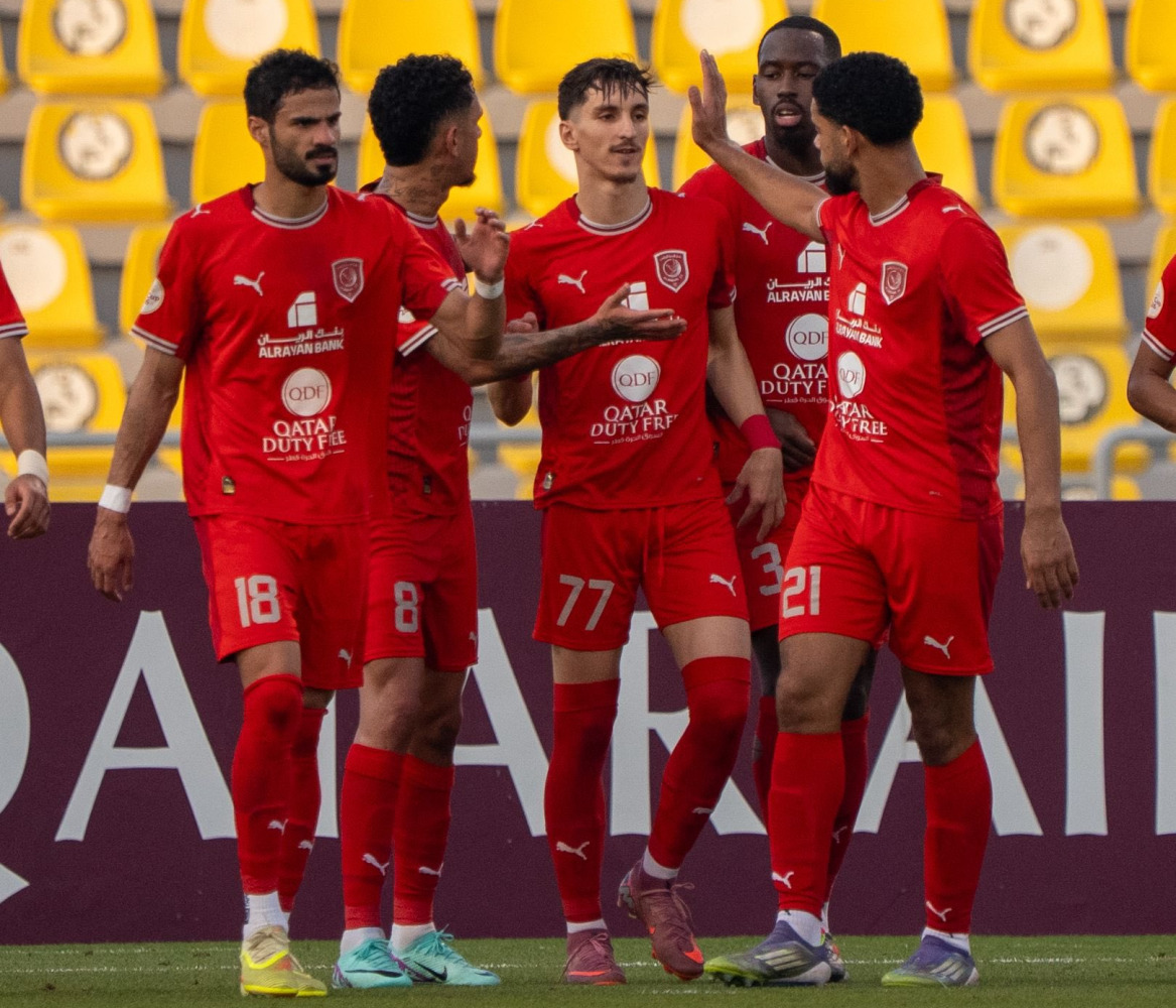 Al Duhail’s Adel Boulbina (centre) celebrates with teammates. 