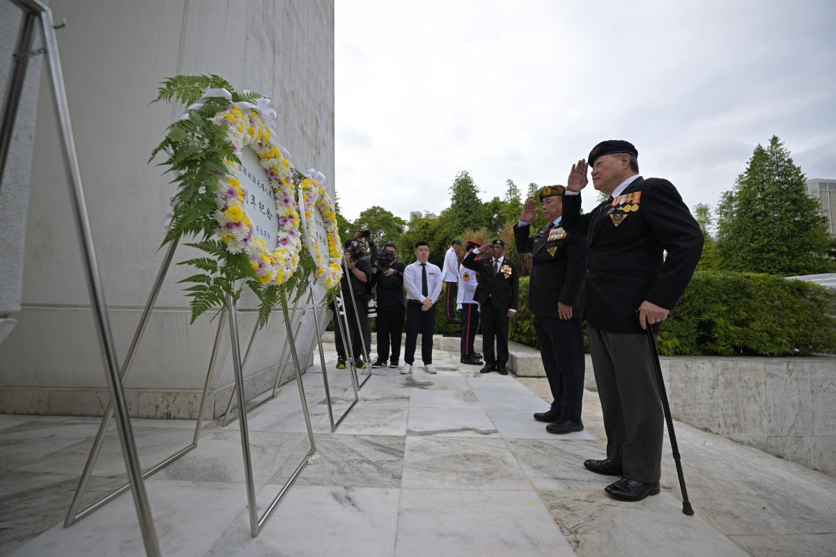 Representatives of retired veterans of the Singapore Armed Forces salute during a memorial ceremony to commemorate civilians who died during the Japanese occupation in World War II, in Singapore, Feb. 15, 2026. (Photo by Then Chih Wey/Xinhua)