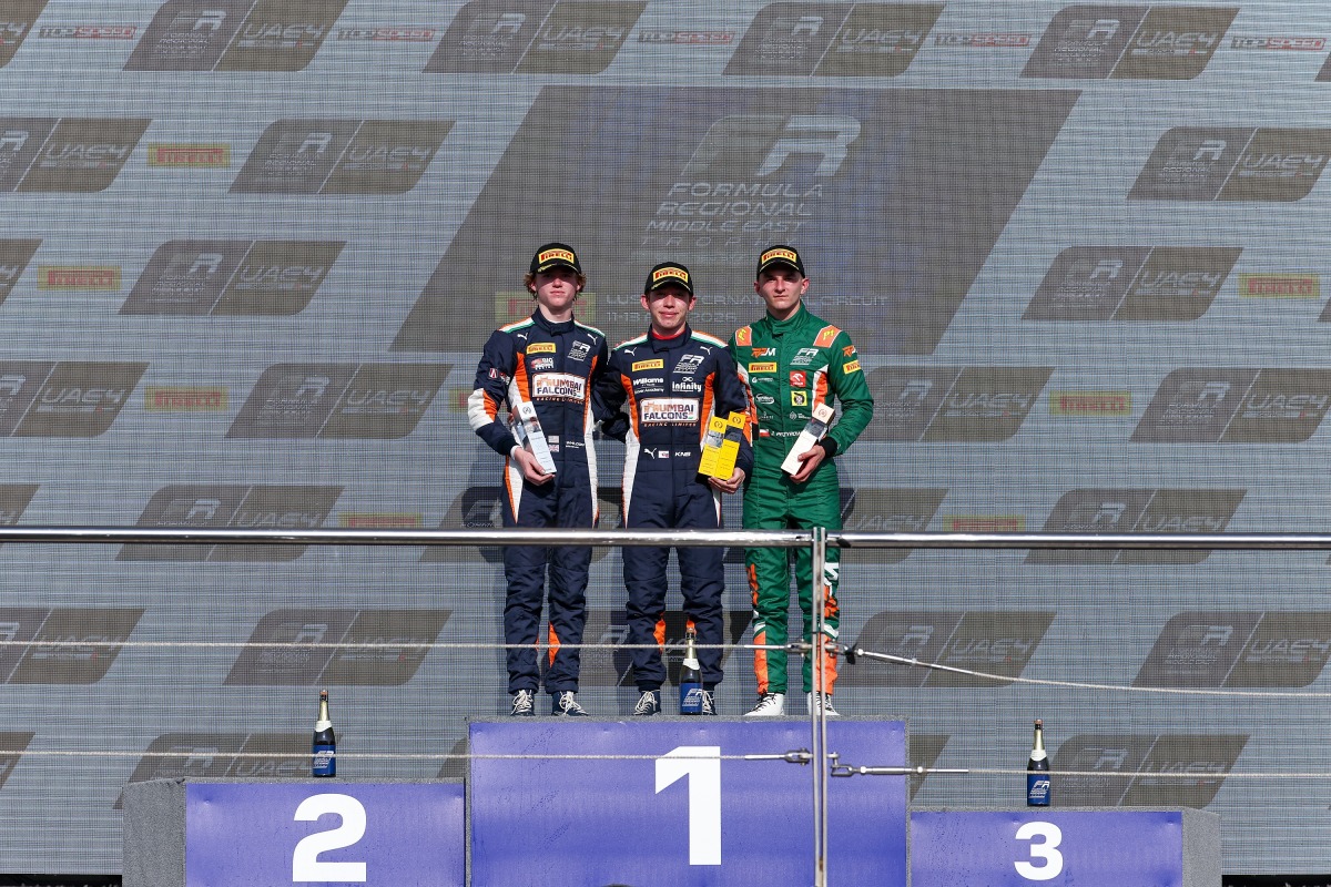 The podium winners pose for photos.