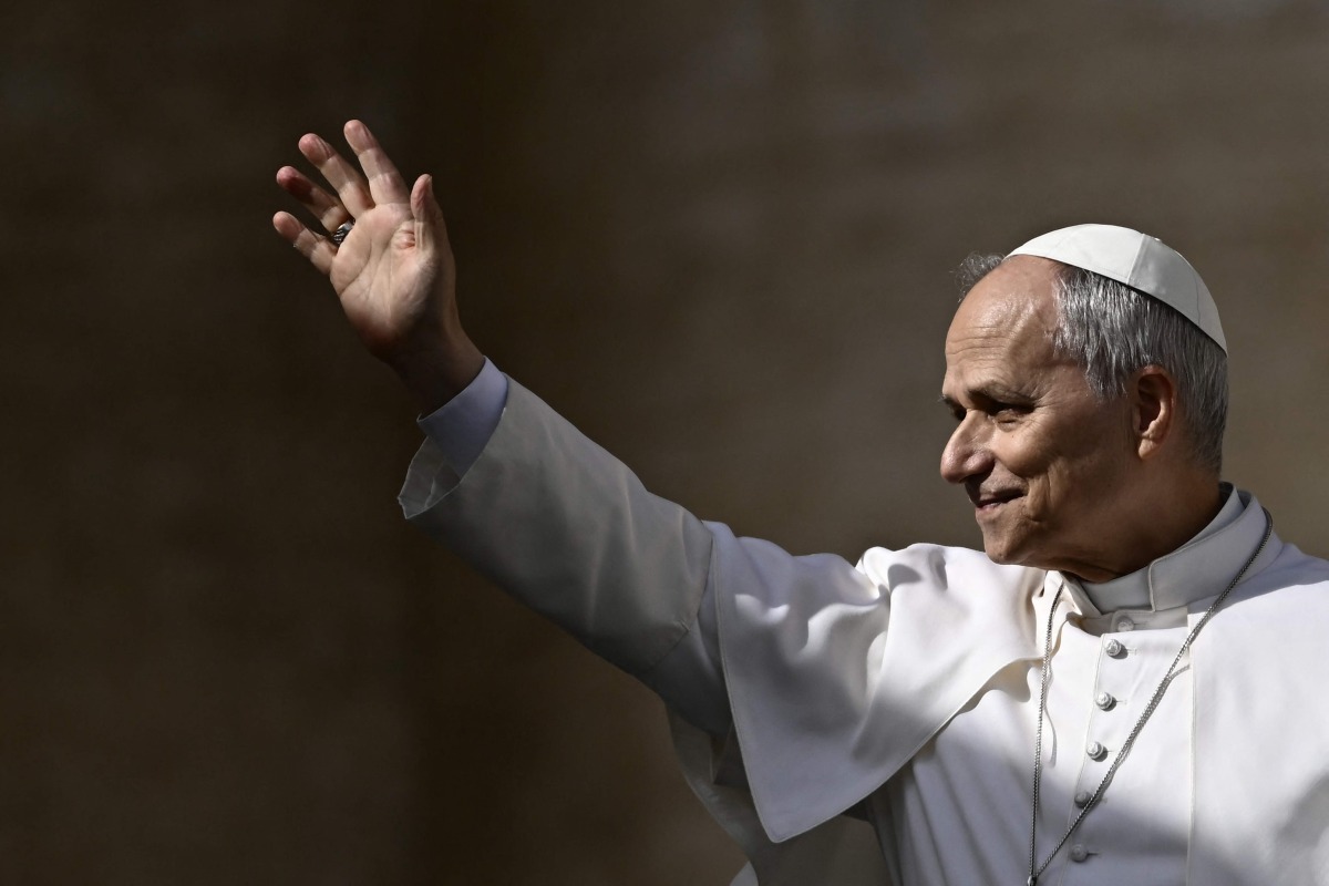 Pope Leo XIV waves to the crowd during the weekly general audience at St Peter's Square in The Vatican on February 18, 2026. Photo by Filippo MONTEFORTE / AFP