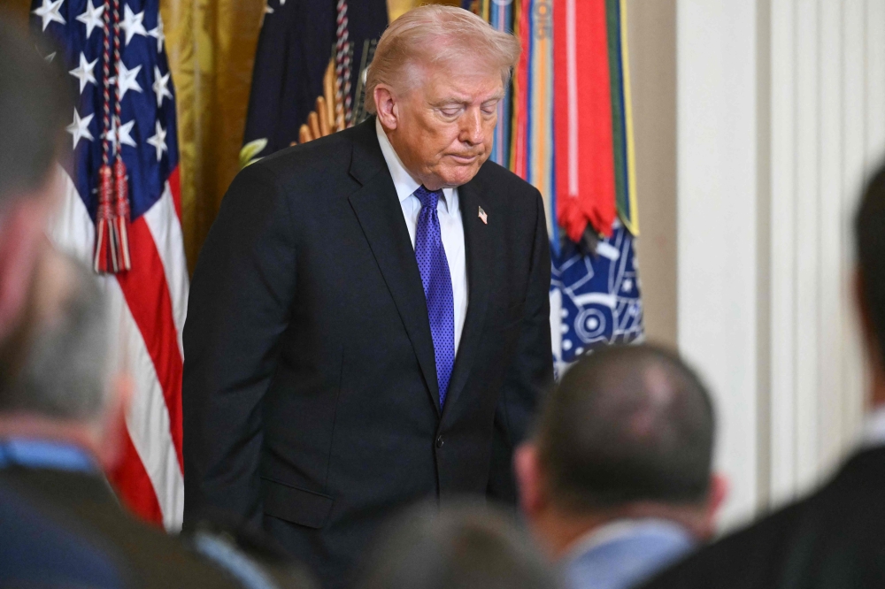 US President Donald Trump departs the stage after hosting a Medal of Honor ceremony in the East Room of the White House on March 2, 2026, in Washington, DC. (Photo by SAUL LOEB / AFP)