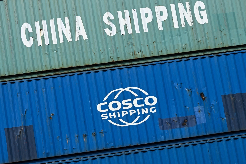 (Files) Containers of China Shipping and Cosco shipping companies are stacked at a transshipment station in Frankfurt am Main, western Germany, on April 15, 2025.  (Photo by Kirill Kudryavtsev / AFP)