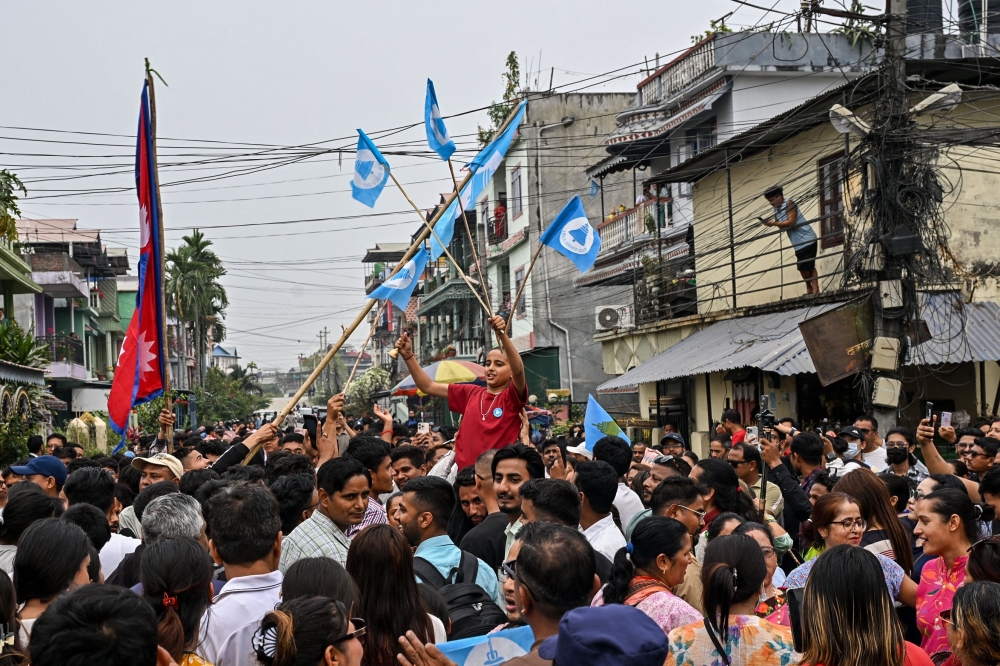 Supporters of the Rastriya Swatantra Party (RSP) celebrate outside the counting centre at Damak in Jhapa district on March 7, 2026. (Photo by Prakash Mathema / AFP)