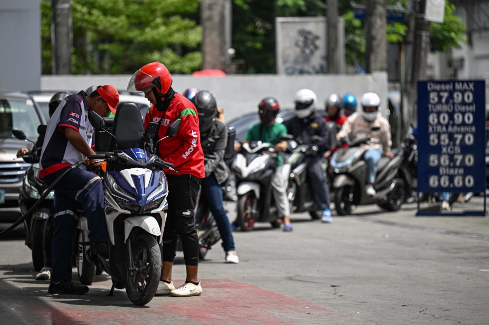 Motorists queue at a gas station amid rising petrol prices in Quezon City, Metro Manila on March 9, 2026. (Photo by Jam Sta Rosa / AFP)