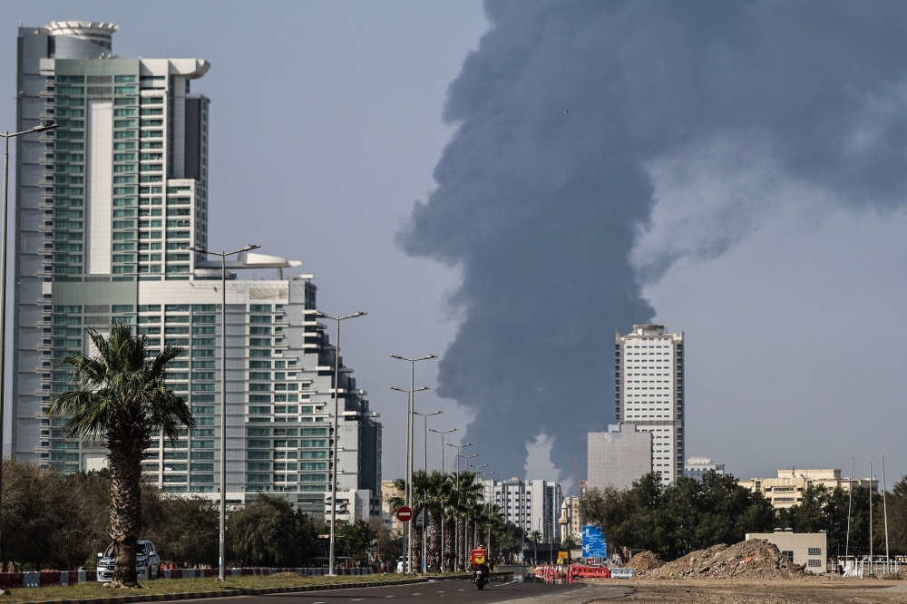 Smoke rises from the direction of an energy installation in the Gulf emirate of Fujairah on March 14, 2026. (Photo by AFP) 