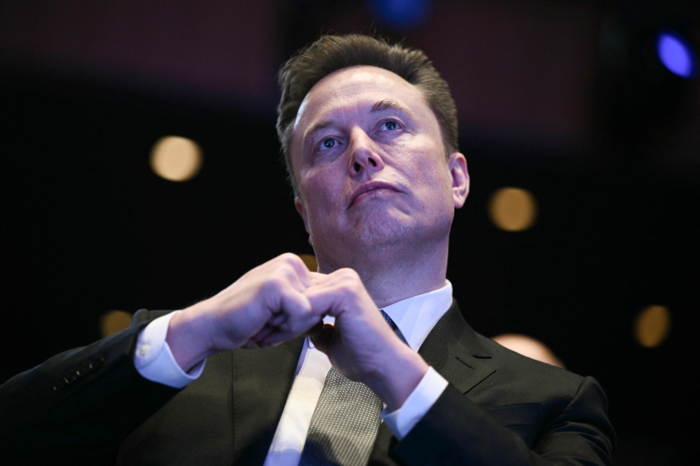 (Files) Elon Musk looks on at the John F. Kennedy Center for the Performing Arts in Washington, DC on November 19, 2025. (Photo by Brendan Smialowski / AFP)