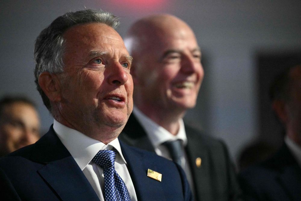 US Special Envoy to the Middle East Steve Witkoff (L) and FIFA President Gianni Infantino smile as US President Donald Trump speaks during the Future Investment Initiative (FII) Summit in Miami Beach, Florida, on March 27, 2026. (Photo by Mandel NGAN / AFP)