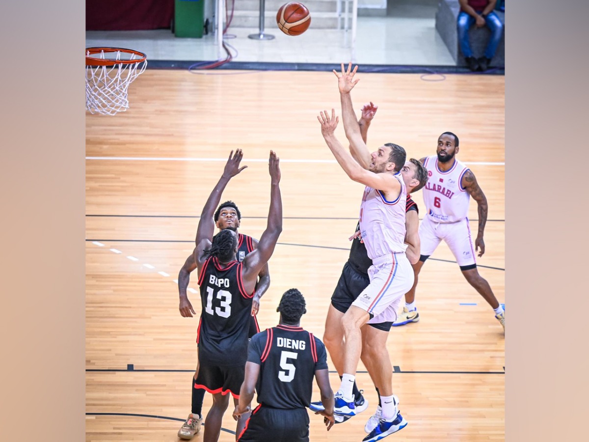 Al Arabi's Elmedin Kikanovic (third right) shoots to score.