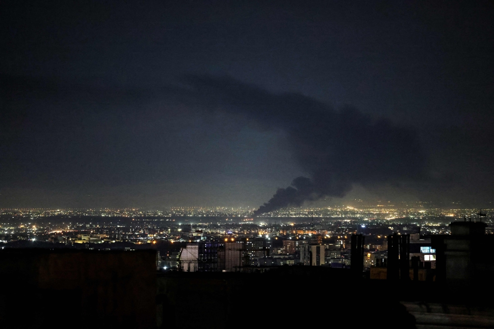 Smoke rises from the site of a US-Israeli strike on the Iranian capital Tehran on April 7, 2026. (Photo by Atta Kenare / AFP) 