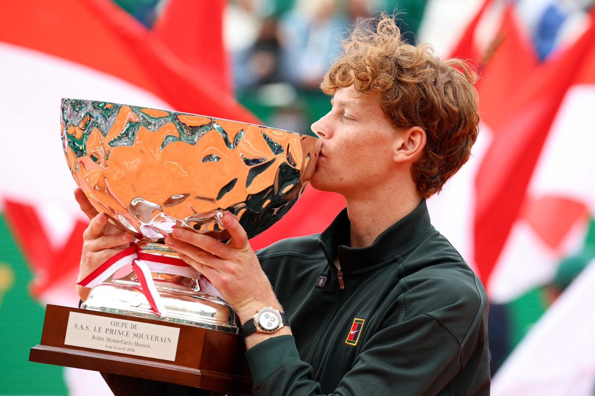 Italy's Jannik Sinner celebrates after winning the Monte Carlo ATP Masters Series Tournament final tennis match against Spain's Carlos Alcaraz on Court Rainier III at the Monte-Carlo Country Club in Roquebrune-Cap-Martin, south-eastern France on April 12, 2026. (Photo by Valery HACHE / AFP)