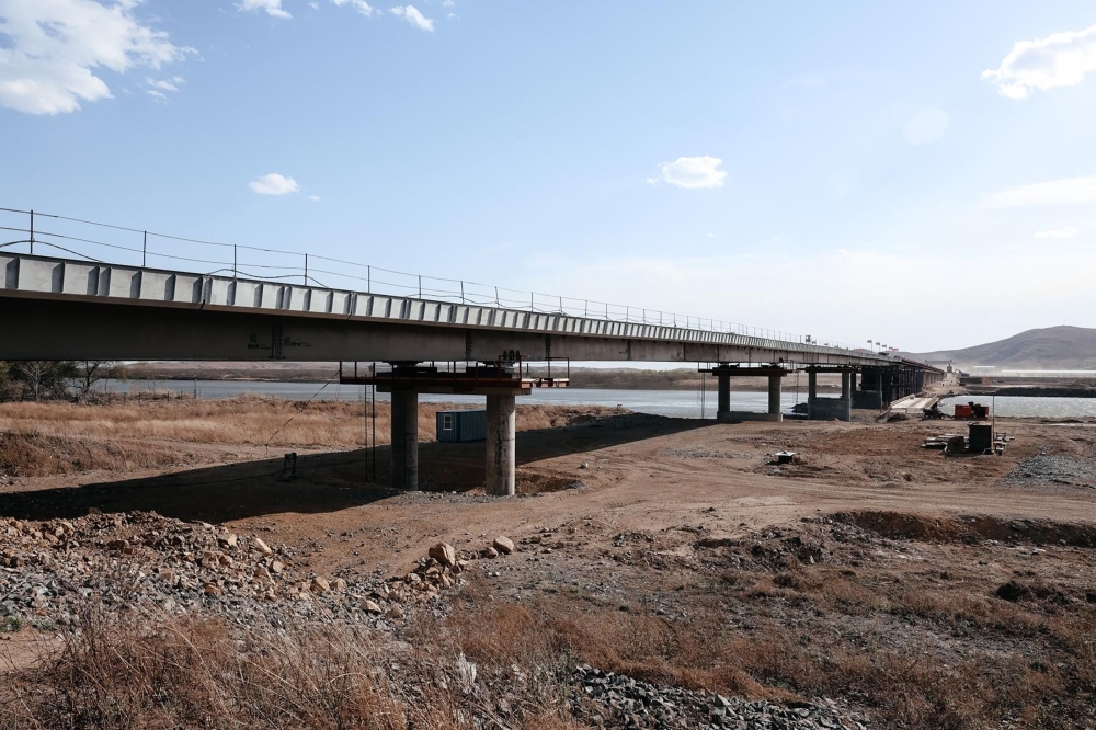 This handout image released by the Russian Transport Ministry on April 21, 2026, shows the under construction road bridge over the Tumen River connecting Russia and North Korea, set to open this summer. (Photo by Handout / Russian Transport Ministry / AFP) 