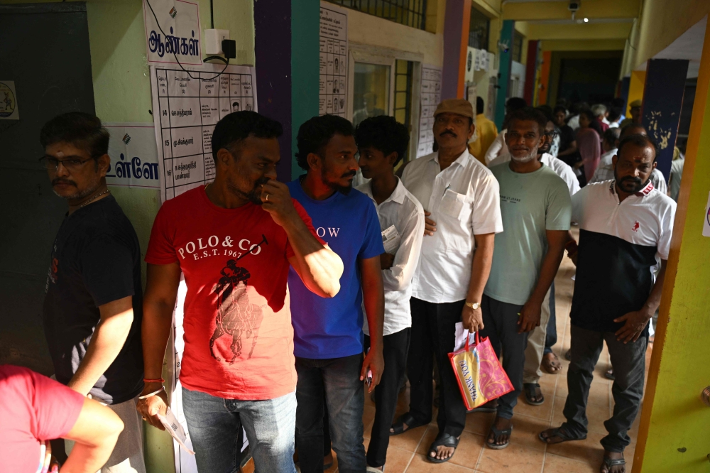 Voters queue to cast their vote outside a polling station during the 2026 Tamil Nadu Legislative Assembly elections in Chennai on April 23, 2026. (Photo by R.Satish BABU / AFP)