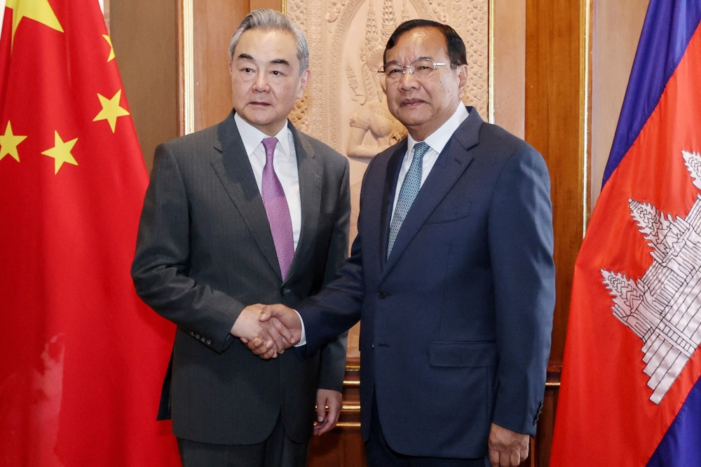 CAMBODIA-CHINA-DIPLOMACY
This handout photo taken and released by Agence Kampuchea Press (AKP) on April 23, 2026 shows Prak Sokhonn (R), Cambodian Deputy Prime Minister and Minister of Foreign Affairs and International Cooperation, shaking hands with China's Foreign Minister Wang Yi (L) during a meeting at the Ministry of Foreign Affairs in Phnom Penh. China's top diplomat Wang Yi is on a three-country tour of Southeast Asia this week, visiting Thailand and Myanmar after a first stop in Cambodia, Chinese officials said. (Photo by Handout / Agence Kampuchea Press (AKP) / AFP) 