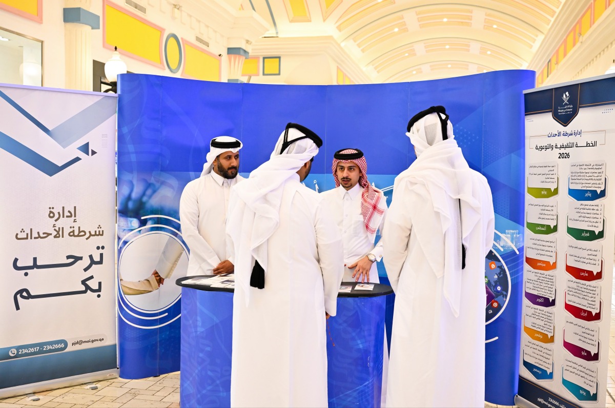 Visitors interacting with an MoI representative at the exhibition.