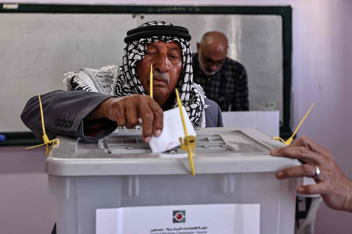 A Palestinian man casts his ballot at a polling station during municipal elections in Palestinian town of Birzeit, north of Ramallah in the Israeli-occupied West Bank on April 25, 2026. (Photo by Zain JAAFAR / AFP)
