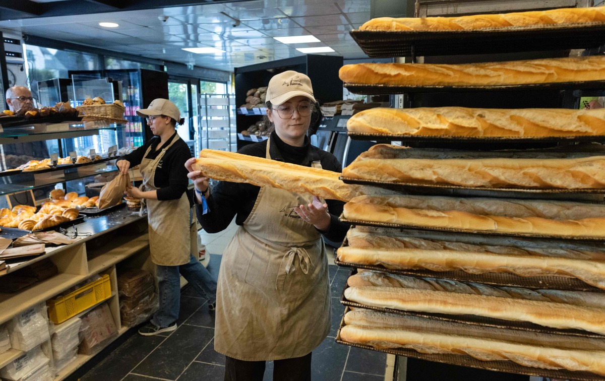 An employee works in a bakery in Quimper, western France, on May 1, 2026. Photo by Fred TANNEAU / AFP