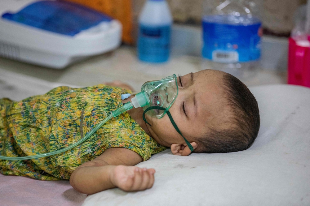 A child diagnosed with measles receives treatment inside a paediatric ward at the Bangladesh Shishu Hospital and Institute in Dhaka on May 6, 2026. (Photo by Salahuddin Ahmed / AFP)