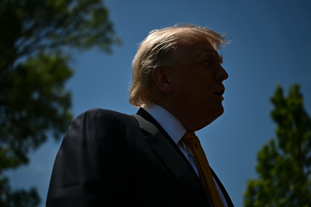 US President Donald Trump speaks to the press before walking to board Marine One as he departs from the South Lawn of the White House in Washington, DC, on May 12, 2026. (Photo by Kent Nishimura / AFP)
 
