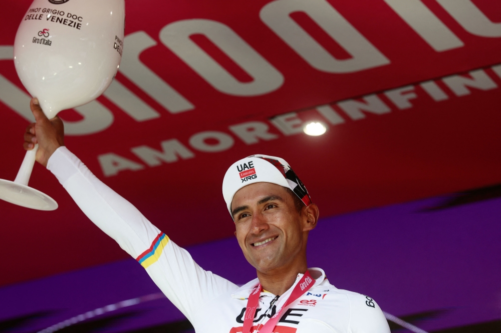 UAE Team Emirates - XRG Ecuadorian rider Jhonatan Narvaez celebrates on the podium after winning the 8th stage of the Giro d'Italia 2026. (Photo by Luca Bettini / AFP)
