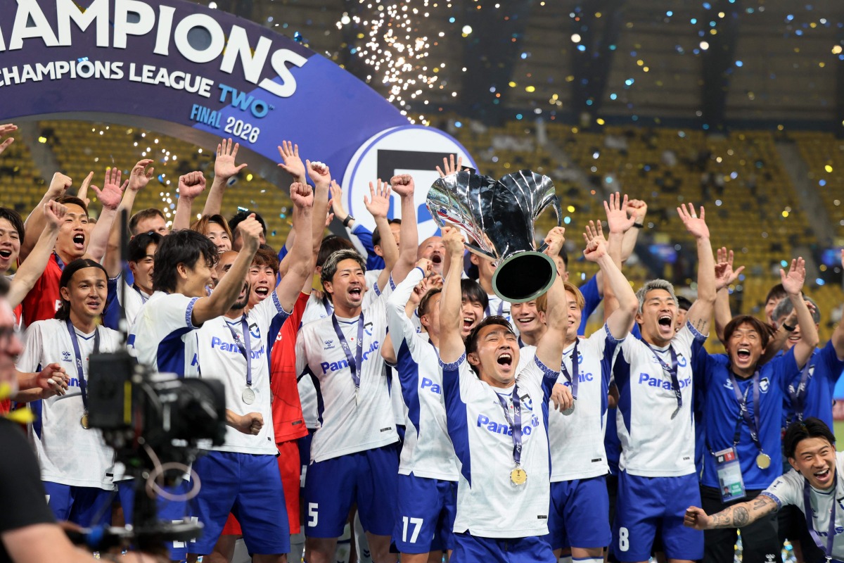 Gamba Osaka's players pose with the trophy after winning the 2026 AFC Champions League Two final football match between Al-Nassr and Gamba Osaka at the Al-Awwal Park Stadium in Riyadh on May 16, 2026. (Photo by Fayez NURELDINE / AFP)