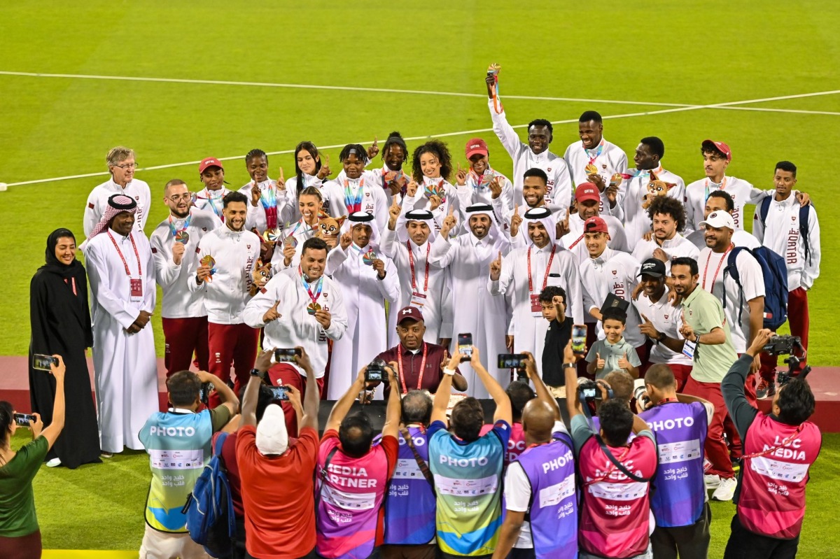 Qatar Athletics Federation President Mohammed Issa Al-Fadala celebrates with Team Qatar's medal winners.