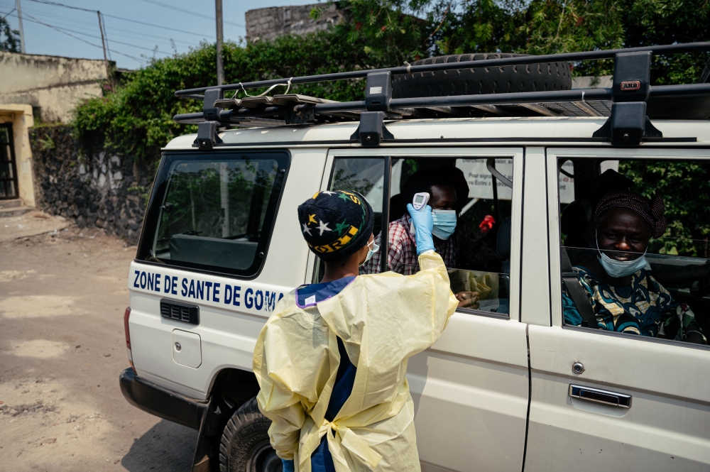 A visitor has their temperature checked by a health worker before entering Kyeshero Hospital, as part of Ebola prevention measures in Goma on May 18, 2026. (Photo by Jospin Mwisha / AFP)
 