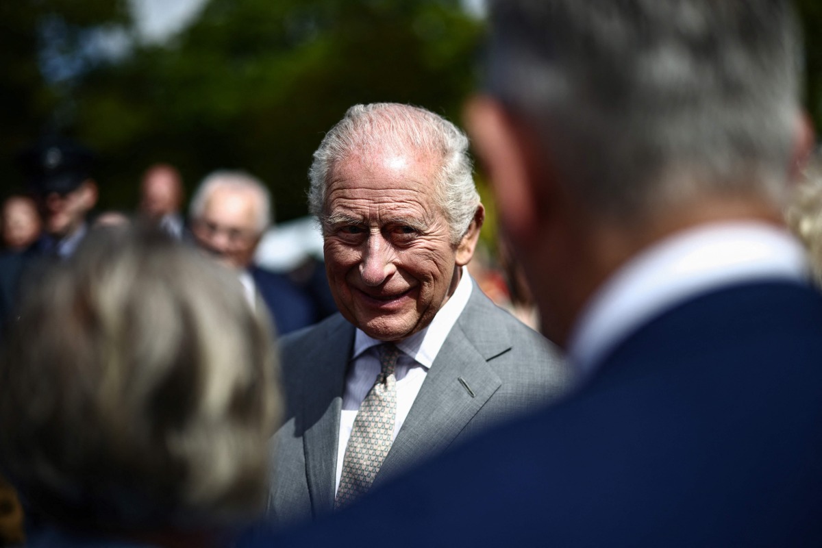 Britain's King Charles III attends a garden party at Hillsborough Castle in Hillsborough, Northern Ireland on May 20, 2026, on the second day of a three-day royal visit to Northern Ireland. (Photo by Henry NICHOLLS / POOL / AFP)