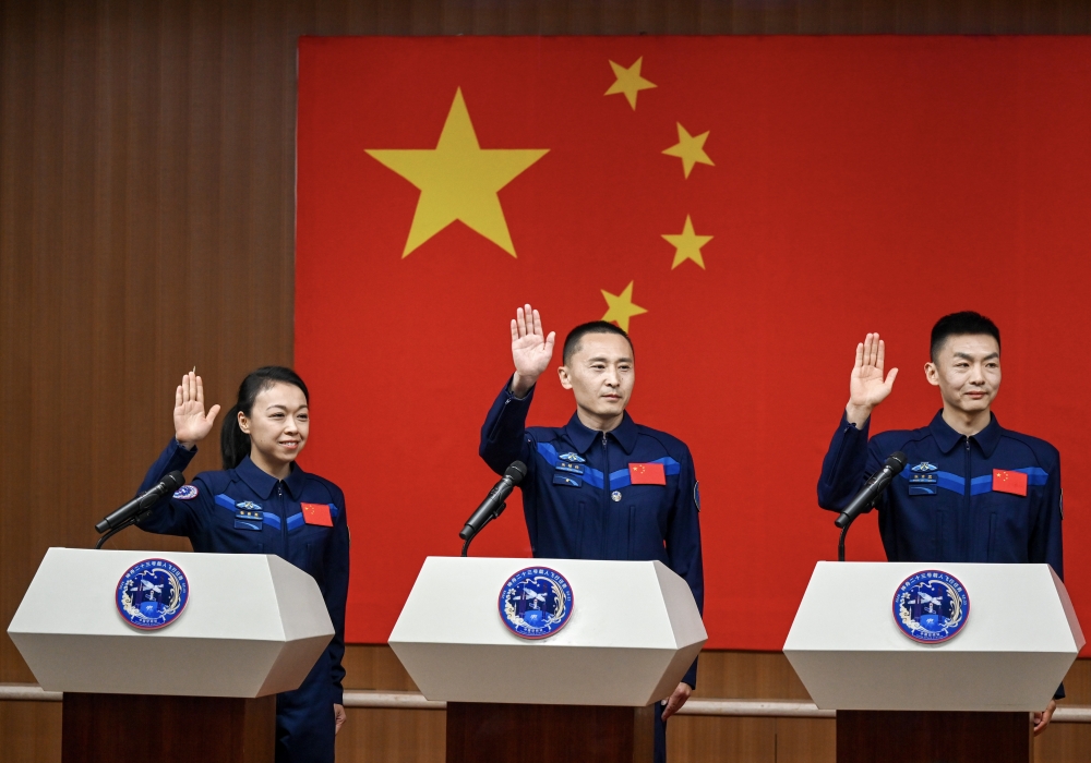 Chinese astronauts Zhu Yangzhu (C), Zhang Zhiyuan (R) and Lai Ka-ying, for the upcoming Shenzhou-23 crewed spaceflight mission, meet the press at the Jiuquan Satellite Launch Center in northwest China, May 23, 2026. (Xinhua/Lian Zhen)