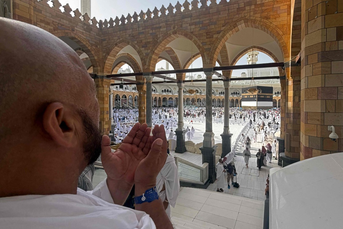 A Muslim worshipper prays near the Kaaba, Islam's holiest shrine, at the Grand Mosque complex in the holy city of Makkah on May 22, 2026, ahead of the annual Hajj pilgrimage. (Photo by Zain JAAFAR / AFP)