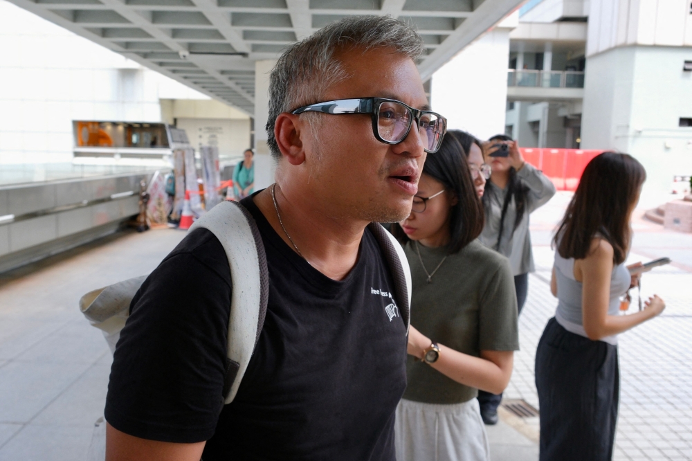 Ronson Chan, a journalist and former chairman of the Hong Kong Journalists Association, wearing a black shirt that reads 
