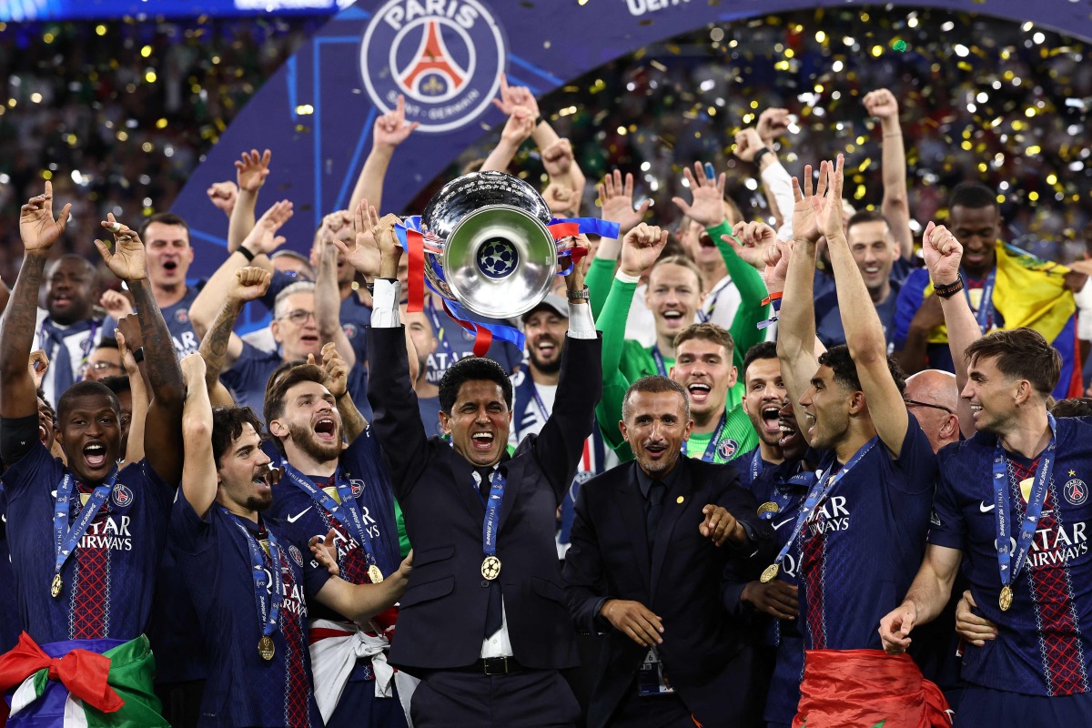 Paris Saint Germain's president Nasser al-Khelaifi (C) lifts the trophy as he celebrates with his players winning the UEFA Champions League final football match between Paris Saint-Germain (PSG) and Arsenal FC at the Puskas Arena in Budapest on May 30, 2026. (Photo by FRANCK FIFE / AFP)