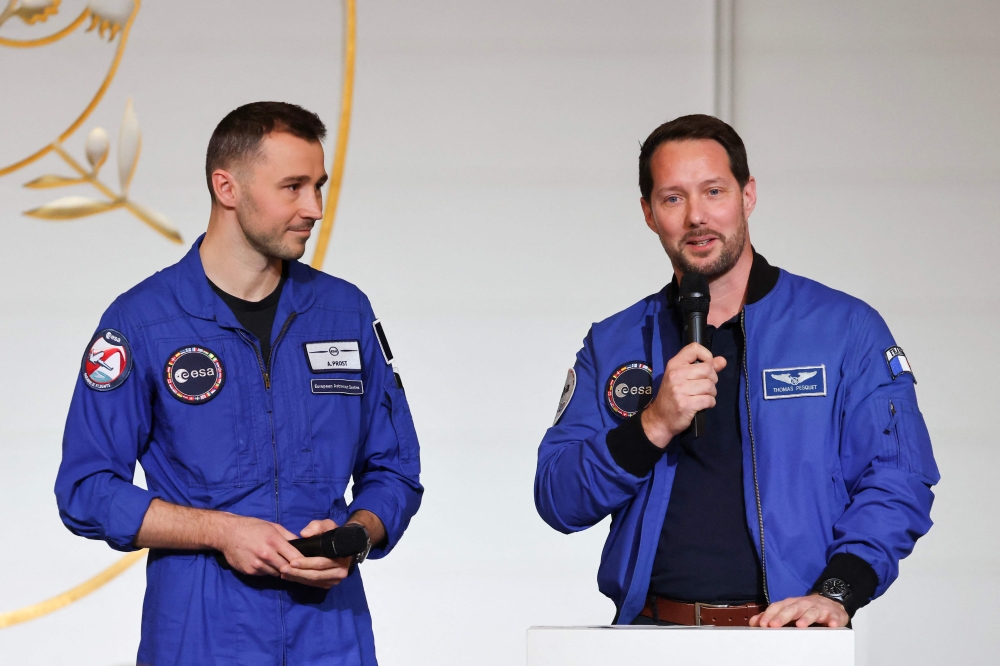 (Files) ESA (European Space Agency) French astronaut Thomas Pesquet (R) next to French astronaut Arnaud Prost addresses the audience at the presidential Elysee Palace in Paris on February 5, 2026. (Photo by Ludovic Marin / Pool / AFP)