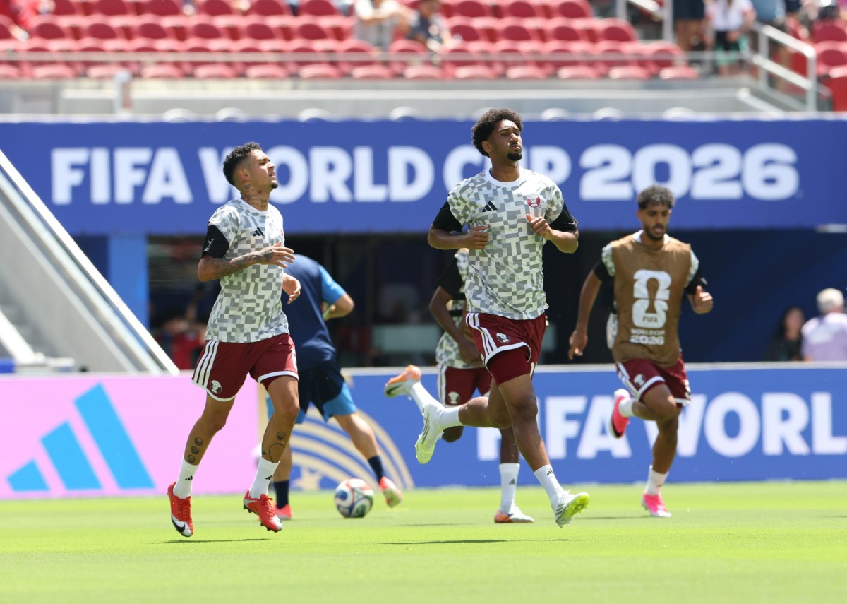 Qatar's Edmilson Junior (left), Homam Al Amin (centre) and Jassim Jaber warm up ahead of match against Switzerland.
