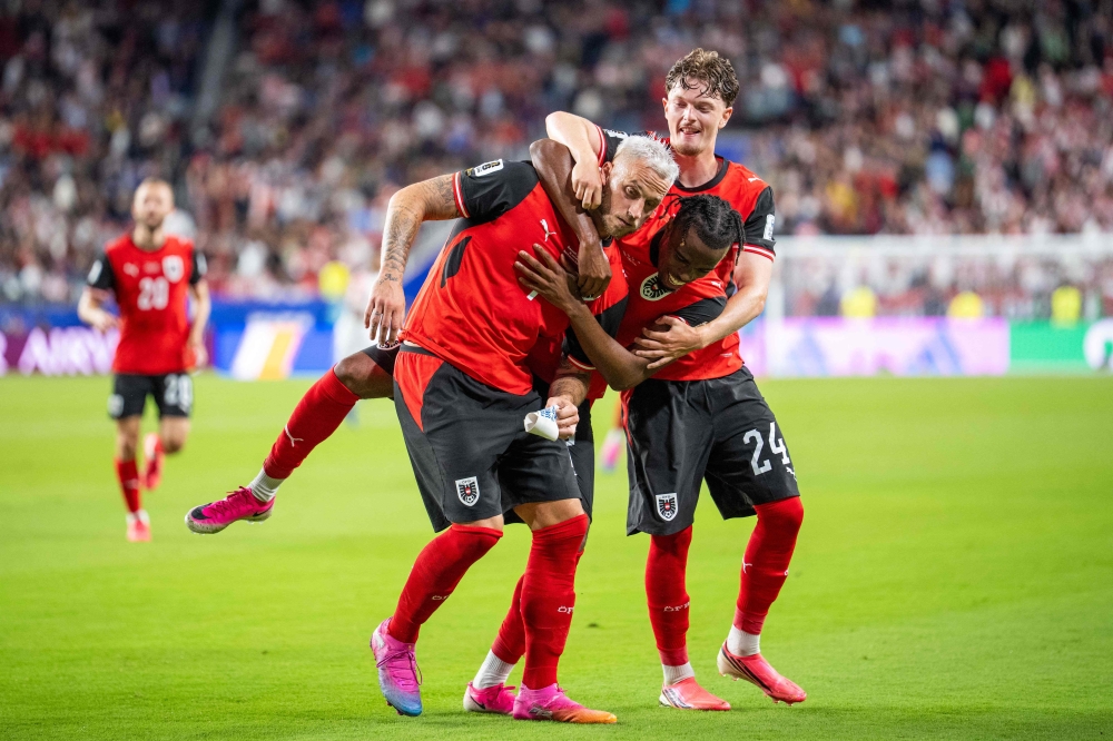 Austria's forward #07 Marko Arnautovic (L), celebrate with Austria's midfielder #17 Carney Chukwuemeka and Austria's midfielder #24 Paul Wanner after scoring a penalty shot during the 2026 World Cup Group J football. Photo by Georg Hochmuth / APA / AFP