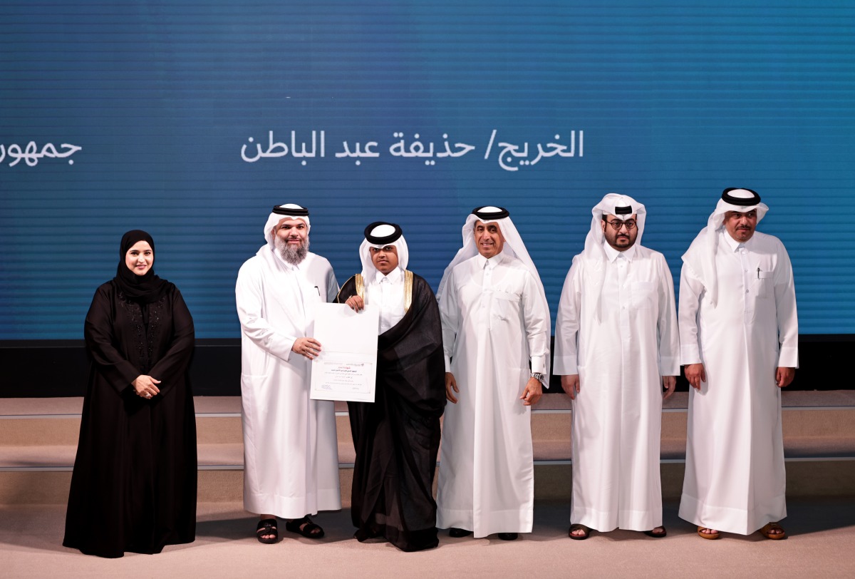 Undersecretary of the Ministry of Awqaf and Islamic Affairs Sheikh Khalid bin Mohammed bin Ghanem Al Thani honours a graduate during the ceremony, while Undersecretary of the Ministry of Education and Higher Education Dr. Ibrahim bin Saleh Al Nuaimi, looks on. Pic: Salim Matramkot/The Peninsula