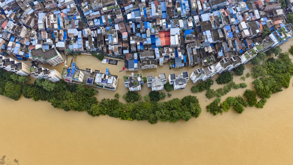 An aerial drone photo taken on June 22, 2026 shows the flood peak passing through the Liujiang River in Liuzhou, south China's Guangxi Zhuang Autonomous Region. (Photo by Li Hanchi/Xinhua)
