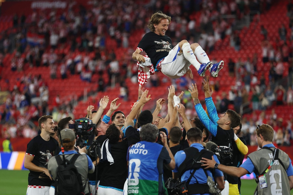 Croatia's midfielder #10 Luka Modric is lifted up by his teammates as they celebrate after winning the 2026 World Cup Group L football match between Panama and Croatia at the Toronto Stadium in Toronto on June 23, 2026. (Photo by Cole Burston / AFP)