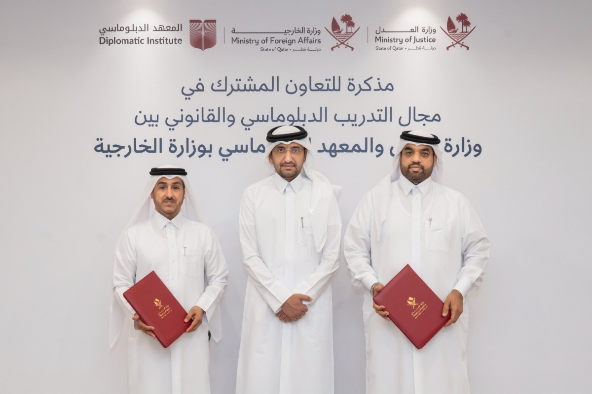 Minister of Justice and Minister of State for Cabinet Affairs H E Ibrahim bin Ali Al Mohannadi with officials from the two entities during the signing ceremony.