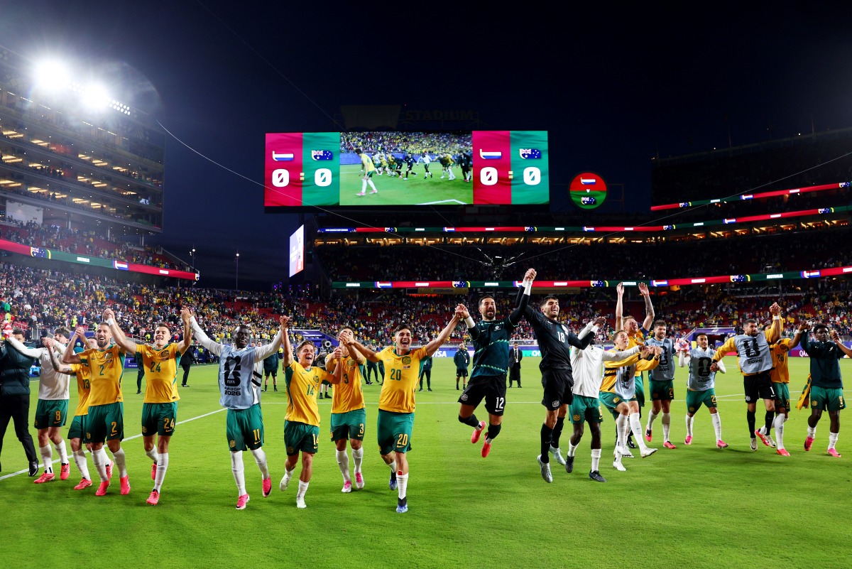 Australia players celebrate after qualifying for the Round of 32. (AFP)