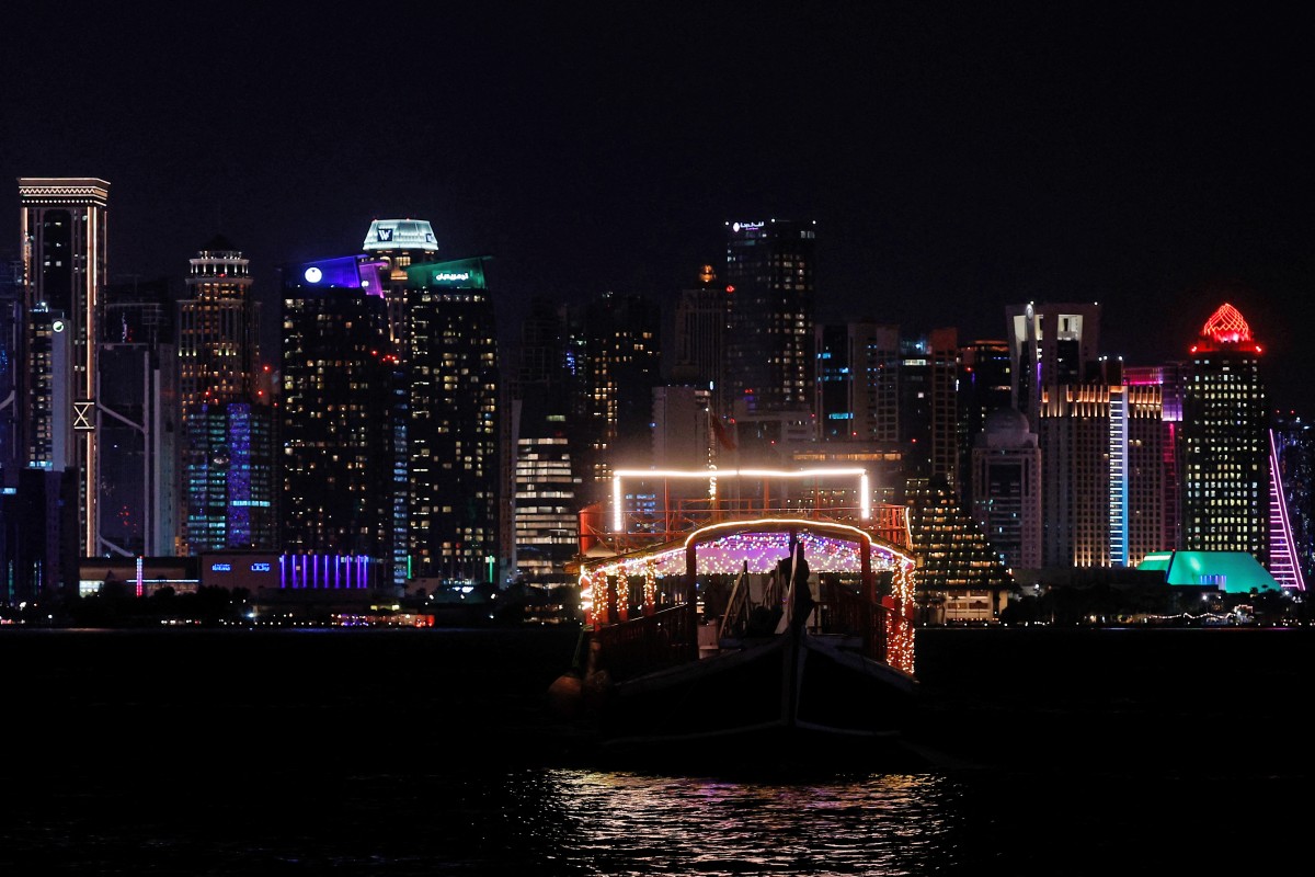 Illuminated skyscrapers are pictured along the corniche promenade in Doha on June 29, 2026. (Photo by Karim Jaafar / AFP)
