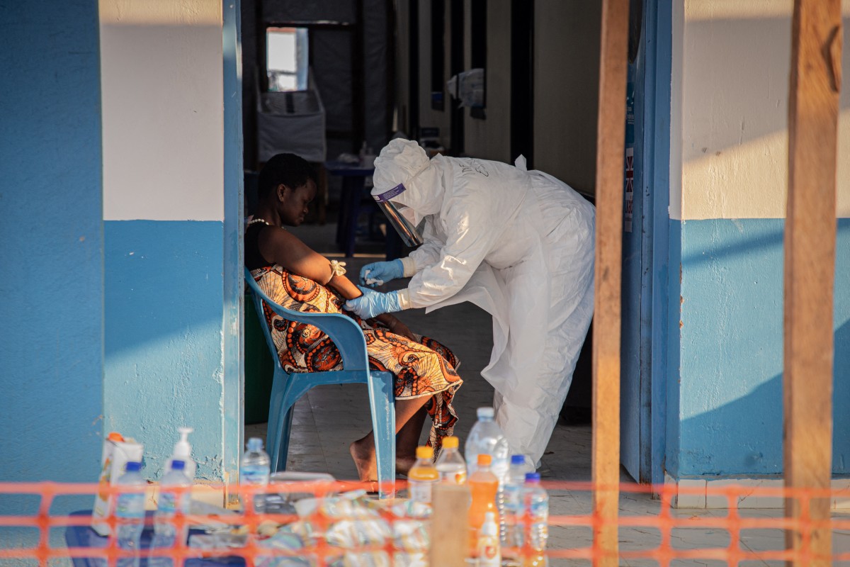 A healthcare worker takes samples from a patient suffering from Ebola virus disease at the Ebola Treatment Center of the Center Médical Évangélique (CME), in Bunia, Ituri, in the east of the Democratic Republic of Congo on June 23, 2026. (Photo by Benediction MURHABAZI / AFP)
