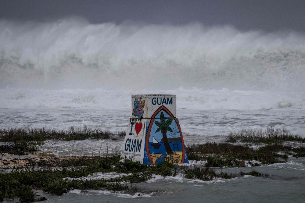 High waves crash against the coastline at a beach as the forecasted Super Typhoon Bavi approaches in Guam on July 5, 2026.(Photo by Yuichi YAMAZAKI / AFP)