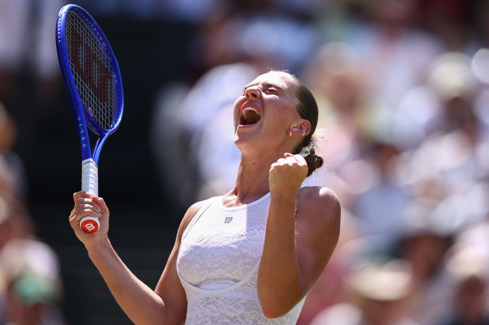 Ukraine's Marta Kostyuk celebrates winning against Italy's Jasmine Paolini during their women's singles quarter-final tennis match on the tenth day of the 2026 Wimbledon Championships at The All England Lawn Tennis and Croquet Club in Wimbledon, southwest London, on July 8, 2026. (Photo by Henry Nicholls / AFP)